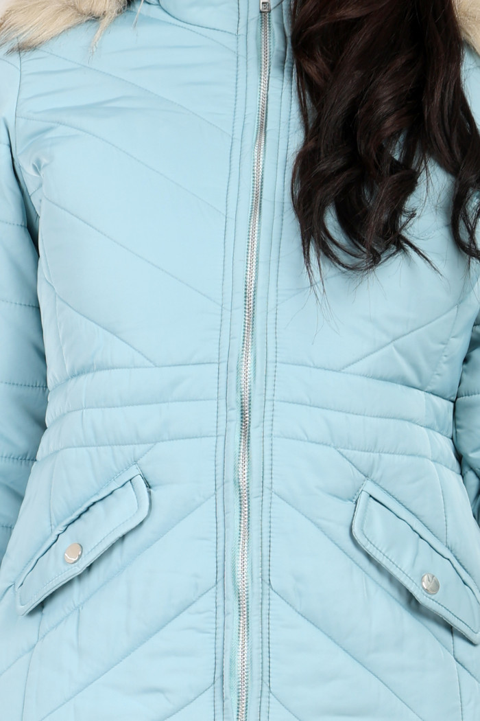 A cropped shot of a woman wearing Coatsnmore’s casual jacket in Sea Green colour with a textured pattern, slash placket pockets, a zip closure and a detachable hood.